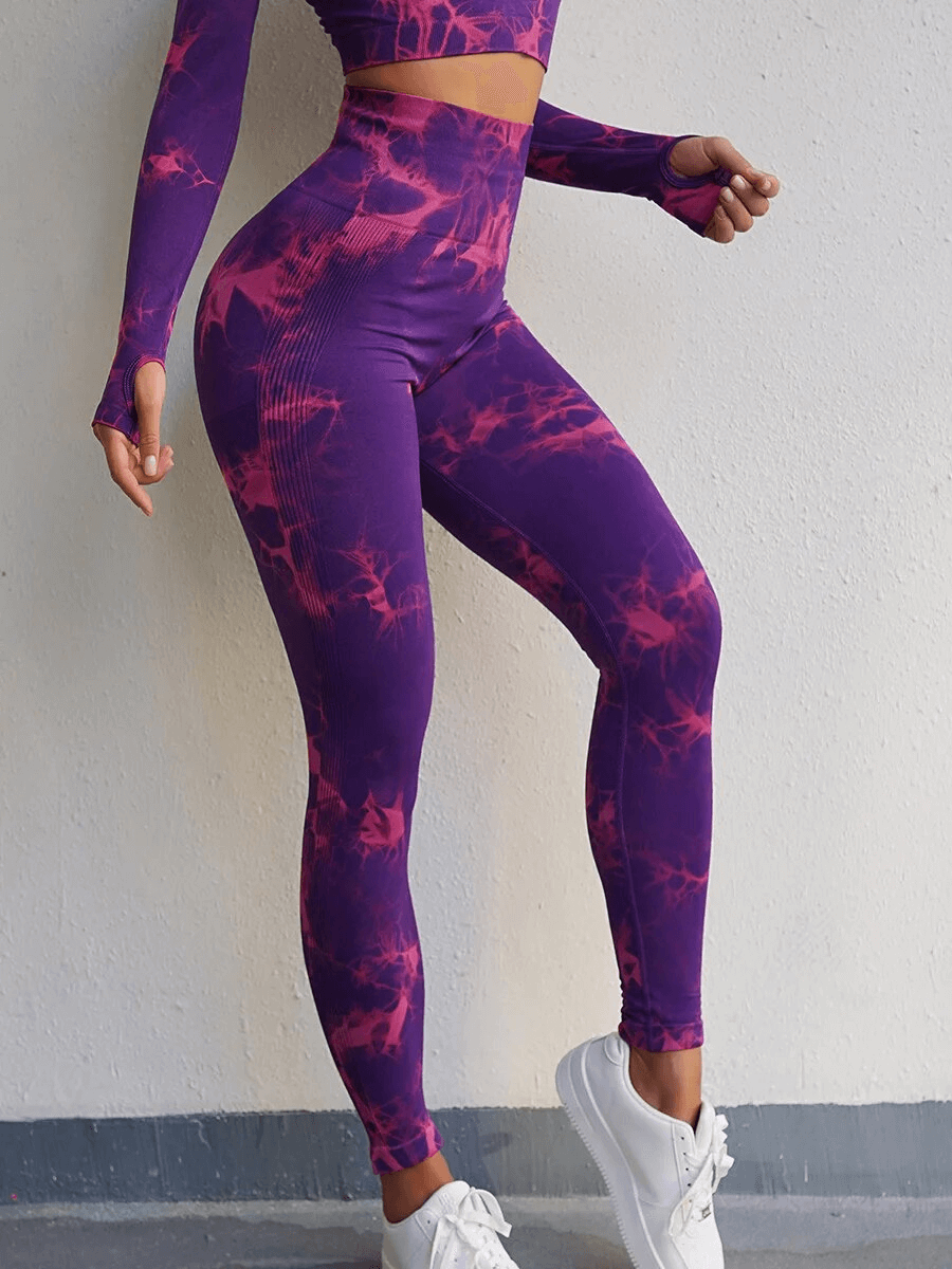 Purple high-waisted elastic sport leggings for women, featuring a tie-dye pattern, perfect for workouts and active comfort.